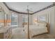 Comfortable main bedroom with a four-poster bed and sliding glass doors leading to the pool at 2016 White Feather Ln, Nokomis, FL 34275
