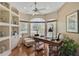 Bright home office with a built-in bookcase and large windows overlooking the yard at 2016 White Feather Ln, Nokomis, FL 34275
