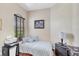 Bedroom with wood floors, twin bed, desk and a bright window at 2025 Lynx Run, North Port, FL 34288