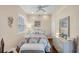 Cozy bedroom with a full-sized bed, wood floors, and light neutral colors at 2025 Lynx Run, North Port, FL 34288