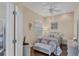 Comfortable bedroom features a ceiling fan, a full-sized bed, and an ensuite bathroom at 2025 Lynx Run, North Port, FL 34288