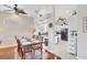 Dining area with view into the kitchen, featuring white cabinets and modern appliances at 2025 Lynx Run, North Port, FL 34288