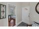 Inviting foyer with white tile floor, white front door, and entry to a bedroom with wood floors at 2025 Lynx Run, North Port, FL 34288