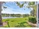 Lush green lawn by the tranquil lake view on a sunny day, showcasing the beautiful natural surroundings at 2025 Lynx Run, North Port, FL 34288