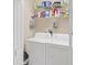 Functional laundry room with modern appliances and ample storage space at 2025 Lynx Run, North Port, FL 34288