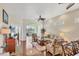 Bright living room with hardwood floors, neutral walls, ceiling fan, and view of a screened-in lanai at 2025 Lynx Run, North Port, FL 34288