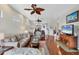 Bright living room with hardwood floors and view of a dining area and kitchen at 2025 Lynx Run, North Port, FL 34288