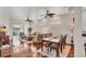Open-concept living and dining area featuring hardwood floors and stylish ceiling fans at 2025 Lynx Run, North Port, FL 34288