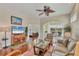 Bright living room with hardwood floors, neutral walls, ceiling fan, and view of a screened-in lanai at 2025 Lynx Run, North Port, FL 34288