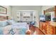 Comfortable main bedroom with bay window, dresser, and coastal decor at 2025 Lynx Run, North Port, FL 34288