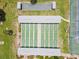 Aerial view of shuffleboard courts and bocce ball with shelters, surrounded by lush greenery at 204 Aspen St, Englewood, FL 34223