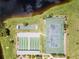 Aerial view showcasing tennis and shuffleboard courts with picturesque lakeside and nature views at 204 Aspen St, Englewood, FL 34223