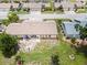 Aerial view showcasing the home's backyard, patio, and surrounding greenery at 204 Aspen St, Englewood, FL 34223