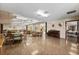 Open concept common area includes multiple tables, seating, and a piano at 204 Aspen St, Englewood, FL 34223