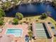 Capture of the community pool area with shuffleboard courts and lakeside scenery for recreation and relaxation at 204 Aspen St, Englewood, FL 34223