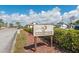 Charming Foxwood Club sign surrounded by lush greenery, creating a welcoming entrance to the community at 204 Aspen St, Englewood, FL 34223