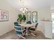 Dining area featuring neutral carpeting, modern chandelier, and large mirror at 204 Aspen St, Englewood, FL 34223