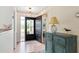 Inviting foyer featuring wood flooring, an updated light fixture, and a decorative cabinet at 204 Aspen St, Englewood, FL 34223