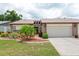 Charming single-story home with a well-manicured lawn and an attached two-car garage at 204 Aspen St, Englewood, FL 34223