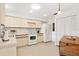 This is a traditional kitchen featuring tile floors, and white appliances at 204 Aspen St, Englewood, FL 34223