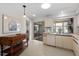 Bright kitchen featuring white cabinetry, stainless steel sink, and a charming decorative display cabinet at 204 Aspen St, Englewood, FL 34223