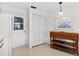 Cozy kitchen area featuring white cabinets and appliances, complemented by a decorative wooden shelving unit at 204 Aspen St, Englewood, FL 34223