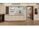 Bright kitchen view with stainless steel appliances, white cabinetry, and ample counter space at 204 Aspen St, Englewood, FL 34223
