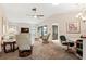 Open concept living room features neutral carpet, and bright natural light at 204 Aspen St, Englewood, FL 34223