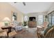 Open living space with neutral carpet, a ceiling fan, and glass sliding doors to the lanai at 204 Aspen St, Englewood, FL 34223
