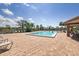Community swimming pool featuring clear blue water, lounge chairs, palm trees and shaded areas at 204 Aspen St, Englewood, FL 34223