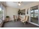 Comfortable sunroom with cozy seating, natural light, and a view of the outside patio at 204 Aspen St, Englewood, FL 34223
