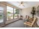 Bright sunroom with neutral tones, a ceiling fan, and views of the lovely landscaped backyard at 204 Aspen St, Englewood, FL 34223