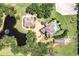 Stunning aerial view of estate with pool, pond, horse riding area, and multiple buildings at 21210 77Th E Ave, Bradenton, FL 34202