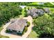 Aerial view of the grand home and detached garage, surrounded by lush greenery and mature trees at 21210 77Th E Ave, Bradenton, FL 34202