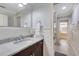 This bathroom has a marble counter, dark vanity, and a view into an adjacent bedroom at 21210 77Th E Ave, Bradenton, FL 34202