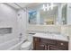 Updated bathroom features a bathtub, shower, and white vanity with marble countertop at 21210 77Th E Ave, Bradenton, FL 34202