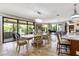 Elegant dining room features glass doors to the backyard patio, chandelier, and an open concept to the kitchen at 21210 77Th E Ave, Bradenton, FL 34202
