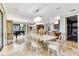 Dining room with backyard access, chandelier, seating for six, piano, and open to the gourmet kitchen at 21210 77Th E Ave, Bradenton, FL 34202