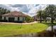 Beautiful home with a pond view, lush lawn and landscape, complemented by a circular driveway at 21210 77Th E Ave, Bradenton, FL 34202