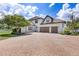 Home exterior featuring a two-car garage and an elegant brick driveway at 21210 77Th E Ave, Bradenton, FL 34202