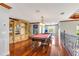 Spacious game room with a billiard table, custom built-ins, and hardwood floors at 21210 77Th E Ave, Bradenton, FL 34202