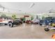 Well-organized garage with multiple vehicles, motorcycles, and ample storage, ideal for hobbyists at 21210 77Th E Ave, Bradenton, FL 34202