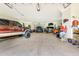 Spacious garage featuring multiple vehicles and ample storage space, perfect for car enthusiasts at 21210 77Th E Ave, Bradenton, FL 34202