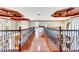 Hallway boasts hardwood floors, decorative railings, and coffered ceilings at 21210 77Th E Ave, Bradenton, FL 34202