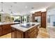 Spacious kitchen features marble countertops, stainless steel appliances, custom cabinetry, and center island with cooktop at 21210 77Th E Ave, Bradenton, FL 34202