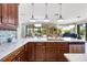 Kitchen featuring wood cabinetry, marble countertops, stainless steel appliances, breakfast bar, and an open view at 21210 77Th E Ave, Bradenton, FL 34202