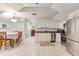 A bright kitchenette features stainless steel appliances and sleek white cabinetry at 21210 77Th E Ave, Bradenton, FL 34202