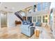 Bright living room with high ceilings, large windows, and stylish blue furniture at 21210 77Th E Ave, Bradenton, FL 34202