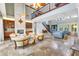 Large, open living area with fireplace, stone floors, high ceilings and two story ceilings at 21210 77Th E Ave, Bradenton, FL 34202