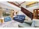 Beautiful living room with a staircase, fireplace, and comfortable leather sofas at 21210 77Th E Ave, Bradenton, FL 34202